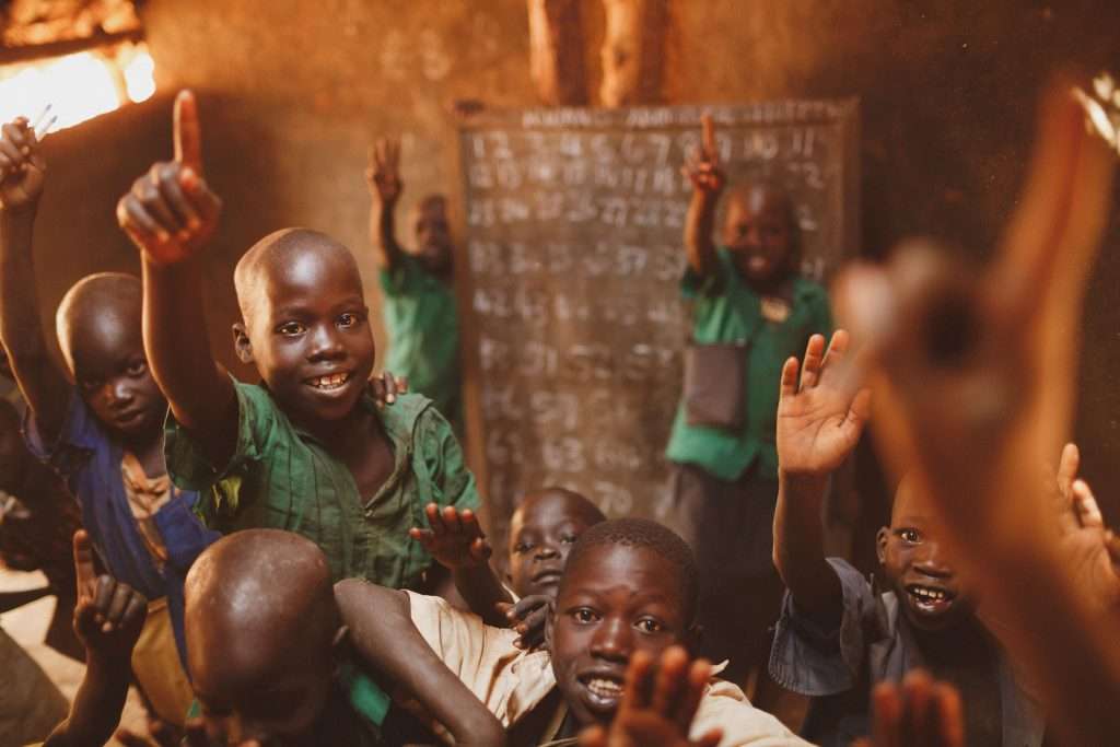 Schoolchildren raising their hands during a lesson in Kitgum, Uganda