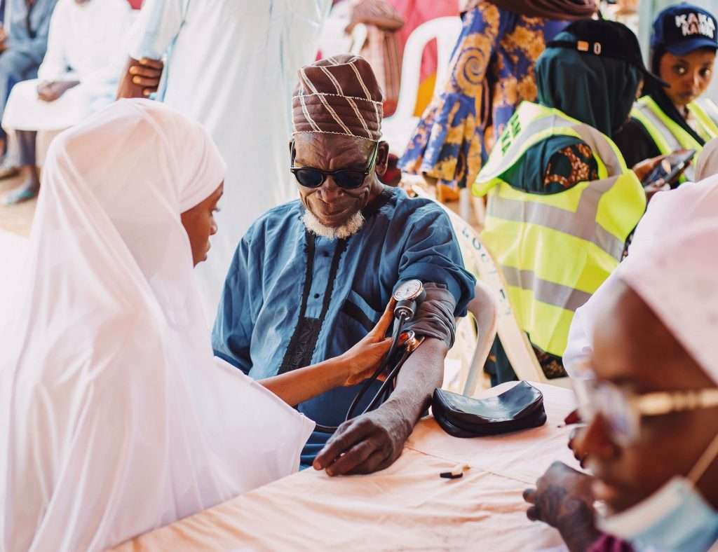 An elderly man receiving care during a community health outreach